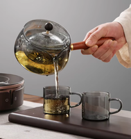 La théière en verre de Borosilicate de vente chaude avec le manche en bois peut 360 la bouilloire en verre tournante pour le thé