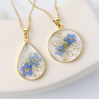 Bijoux de collier en acier inoxydable doré haut de gamme à la mode avec chaîne à maillons vraie fleur et pendentif en résine transparente de fleur séchée