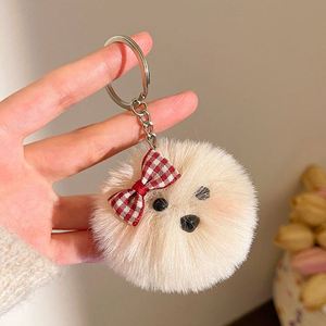 Al por mayor: Llavero y colgante para mochila de perro de peluche con lazo, bola de pompón esponjosa y gafas, diseño de cachorro adorable - Product Image 5