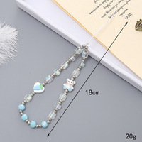 Nouveau style créatif : Lanière de téléphone mignonne avec design ours, carotte et nœud papillon, pendentif caméra CCD, perles de cristal tendance et polyvalentes pour téléphone