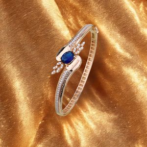 <b>Rose</b> <b>gold</b> ladies bangle with deep blue oval stone and sparkling leaf detailing stylish <b>womens</b> jewellery - Product Image 1