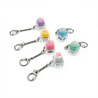En gros, Porte-clés en plastique en forme de patte de chat, anti-stress, type clavier à pression, breloque de sac, porte-clés LED en forme de patte de chat