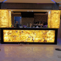 Comptoir de bar lumineux LED commercial de luxe personnalisé en pierre translucide pour boîte de nuit et restaurant
