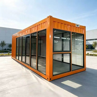 Maisonnette Apple en acier ondulé orange, conteneur habitable avec mur entièrement vitré, double porte, mobilée pour bureau et espace de vie