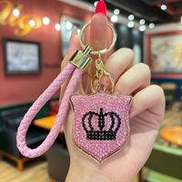 Porte-clés de luxe avec couronne en strass, sangle en cuir tressé, breloque scintillante pour sac et clé de voiture pour femme