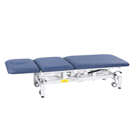 Table de traitement musculaire électrique luxueuse, lit de thérapie de spa de gym avec des caractéristiques réglables et pliables pour l'hôpital et le massage