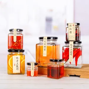 Design personalizzato all'ingrosso chiaro quadrato 100ml 280ml 500ml 730ml barattolo di conservazione degli alimenti barattolo di miele con coperchi a vite per la conservazione degli alimenti del miele