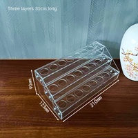 Présentoir en acrylique pour poudres cosmétiques avec design étagé, idéal pour le rangement d'huiles essentielles, de produits de soin et comme table de finition pour le conditionnement.