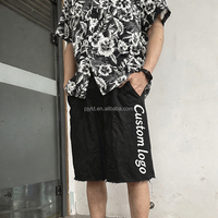 Shorts en molleton de coton noir à ourlet brut, coupe ample, avec logo brodé personnalisé OEM ODM, taille élastique, pour hommes