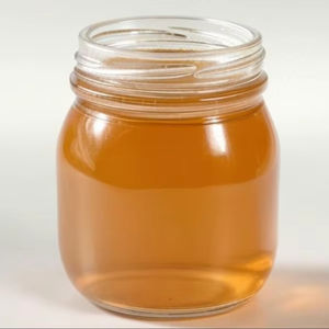 Miel de girofle biologique à texture lisse dorée, arôme riche fraîchement cueilli, naturel pur pour l'exportation, vente en gros, emballage de bouteilles au détail - Product Image 1