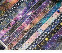 Ensemble de rubans washi style galaxie cosmique mystérieuse avec motifs étoiles, lune et soleil imprimés en feuille, pour les amateurs de journal intime et la décoration de carnets