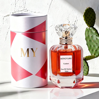 Flacon de parfum hexagonal en verre transparent de luxe 70 ml avec pompe pulvérisatrice, bouchon en acrylique sérigraphié, emballage en boîte cadeau cylindrique
