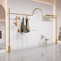 Porte-vêtements mural en métal doré, dernier cri, magasin de vêtements résistant, meilleure qualité