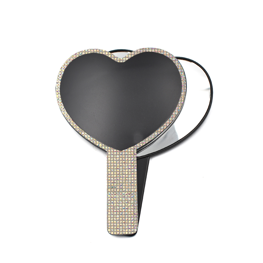 Espejo de mano con forma de corazón negro y pedrería.