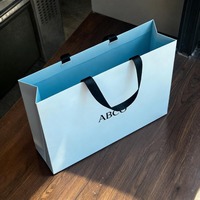 Sac de shopping pour magasin de vêtements en papier robuste, réutilisable, imperméable, laminé, gaufré, mat, avec dorure à chaud personnalisée de luxe