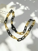 Collier à maillons épais bicolore or et noir avec fermoir pavé de zirconiums cubiques, style trombone