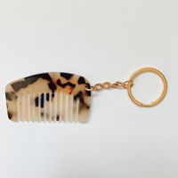 Vente en gros d'usine, modèles variés, logo personnalisé, mini peigne porte-clés portable en acétate pour cheveux