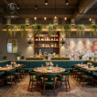 Ensemble de meubles modernes industriels pour café, restaurant, hôtel : table en bois avec pieds métalliques, base en bois, banquette en cuir vert foncé et chaise.