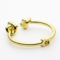 Bracelet manchette tendance à double nœud, ajustable avec fermoir à ressort, en acier inoxydable plaqué or, style jonc simple