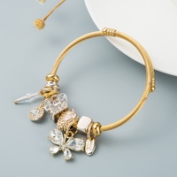 Bracelet en alliage doré incrusté de diamants, style bohème rétro ethnique européen et américain, avec éléphant, papillon et pierres précieuses