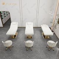 Lit de massage facial à double colonne à base métallique dorée de luxe à 4 moteurs pour salon de beauté