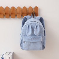 Sac à dos en velours côtelé personnalisé en gros avec oreilles de lapin, poche avant zippée, poches latérales à cordon de serrage, bretelles réglables