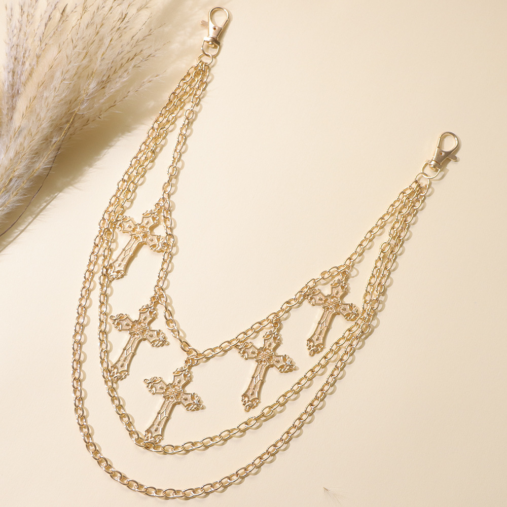 Cadena para pantalón multicapa con cruz dorada.