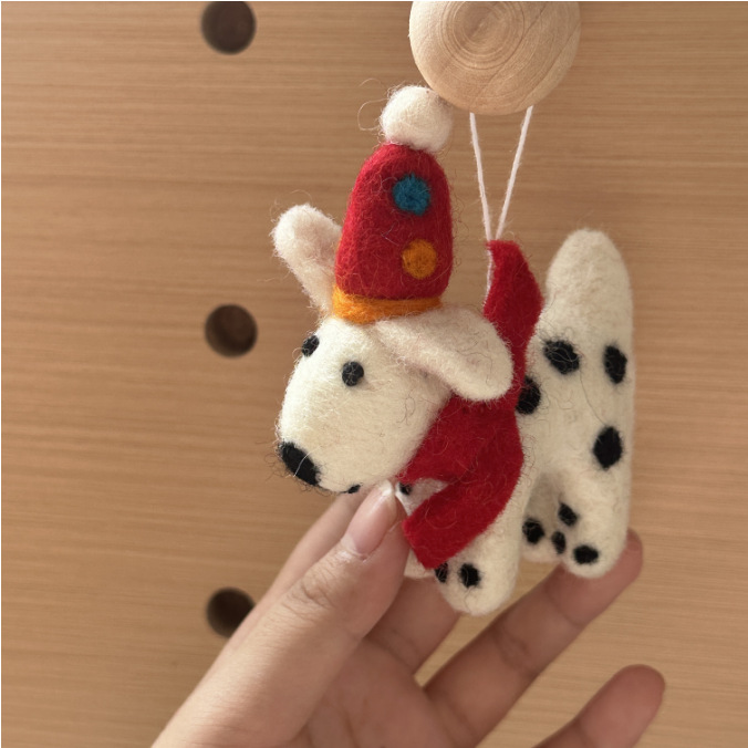 A Dalmatian with a colored red hat