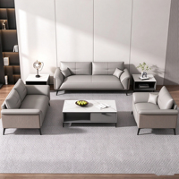 Canapé de bureau moderne et durable de style italien de luxe léger, ensemble table basse en cuir véritable pour zone de réception VIP d'entreprise