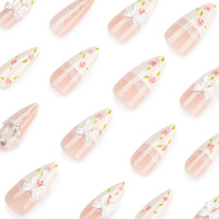 Vente en gros de faux ongles en acrylique de style français |   Charmes personnalisables en dentelle rose nude avec nœud 3D et strass, forme amande, longueur longue