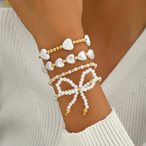 European and American cross-border elegant and versatile heart-shaped faux pearl <b>bracelet</b> four-piece <b>set</b> with bow stacking - Product Image 1