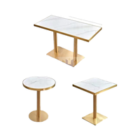 Table de salle à manger commerciale de luxe moderne en acier inoxydable avec pieds dorés et plateau en pierre frittée marbrée pour café et école