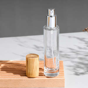 ผู้ผลิตขายส่งขวดน้ำหอมแก้วใสทรงกระบอกขนาด 30 มล. 50 มล. 100 มล. แบบหนา พร้อมฝาไม้ - Product Image 5