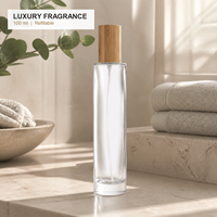 Flacon de parfum rond en verre transparent personnalisé de 100 ml, pulvérisateur à vis XB150, bouchon en bambou, emballage de parfum de luxe rechargeable, logo OEM