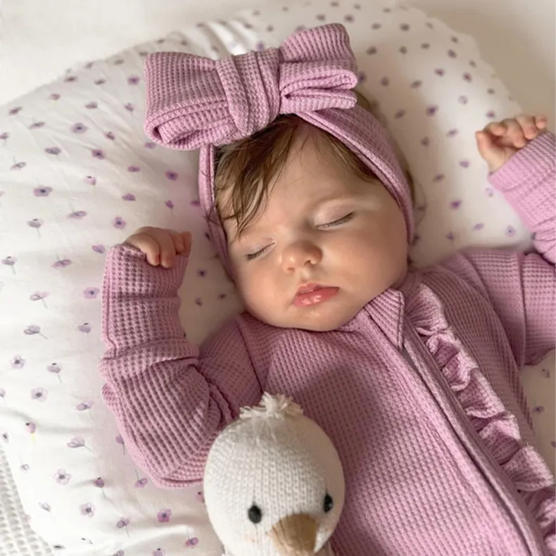Fábrica al por mayor de algodón y bambú bebé mameluco recién nacido manga larga liso bebé gofre algodón orgánico bebé pijamas ropa