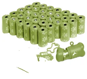Sıcak satış biyobozunur compostable yeşil sevimli köpek pençe desen mini pet yavru tek kullanımlık plastik köpek kaka torbası rulo çöp torbası