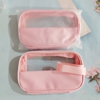 Vente en gros de trousses de maquillage en PVC transparent rose imperméables avec poignée, étiquette privée, grande capacité, sac de maquillage translucide en PU