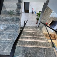 Carrelage en marbre gris foncé avec veines blanches Emperador Cloud pour escaliers de villa intérieurs avec garde-corps en verre trempé, design moderne