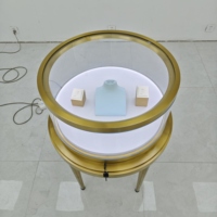 Vitrine à bijoux ovale de luxe en acier inoxydable avec éclairage LED doré, verre incurvé, couleur personnalisable, design durable pour comptoir d'îlot
