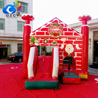 Château gonflable de Noël avec mur de briques et toboggan pour enfants, idéal pour les événements et fêtes de fin d'année à louer