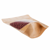 Sac en papier kraft brun en stock, pochette debout avec fermeture éclair sur le dessus et face avant transparente pour l'emballage des noix, des céréales et des fruits secs