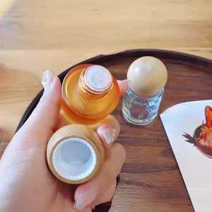 Bouteille en verre vide pour huiles essentielles, 15 ml, 30 ml, avec bouchon rond en bois, nouveau design, logo personnalisé, orange transparente, vente chaude - Product Image 3