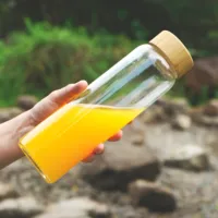 Botella de agua transparente con logotipo personalizado, botella de agua de vidrio de boca ancha de 32oz con funda y tapa de bambú, 1000ml, gran oferta