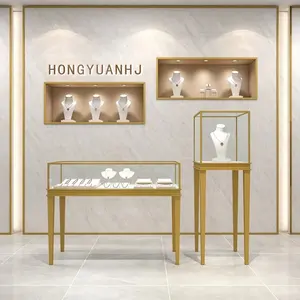 Vitrine d'affichage en acier inoxydable d'or personnalisé au détail d'affichage de magasin de bijoux haut de gamme pour le magasin et le comptoir de bijoux