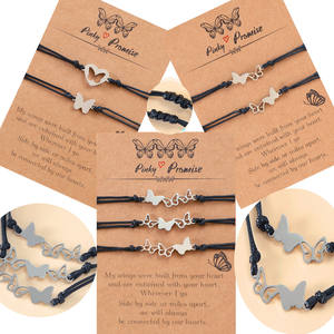 طقم من سوارين للزوجين بتصميم فراشة وقلب مفرغ من الفولاذ المقاوم للصدأ مع بطاقة، سوار صداقة بحبل أسود - Product Image 1