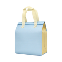 Sac isotherme bicolore bleu-jaune en non-tissé pour le stockage des fruits de mer avec un design contrasté et un intérieur spacieux