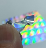 Étiquettes d'emballage anti-contrefaçon personnalisées en argent PET, holographiques fluorescentes à effet de vide, résistantes à l'huile pour téléphones mobiles et écouteurs