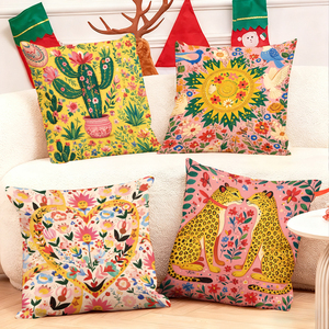 Vibrant floral and animal themed throw pillows decorate cozy living room sofa with festive holiday stockings in background - Product Image 1