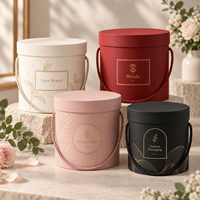Boîte cadeau cylindrique rigide en carton texturé avec poignée en corde ronde, couvercle et base personnalisés avec logo, pour l'emballage de fleurs