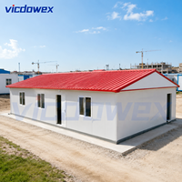 VICDOWEX Maison préfabriquée de luxe contemporaine en forme de T, construction en acier à panneaux sandwich, isolation thermique, site de construction